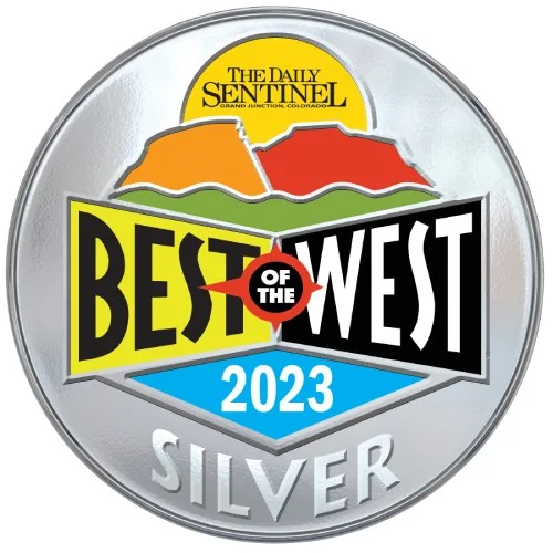 The image shows a silver circle, and inside of it are the ads for “The Daily Sentinel in Grand Junction, Colorado”. With the title of
